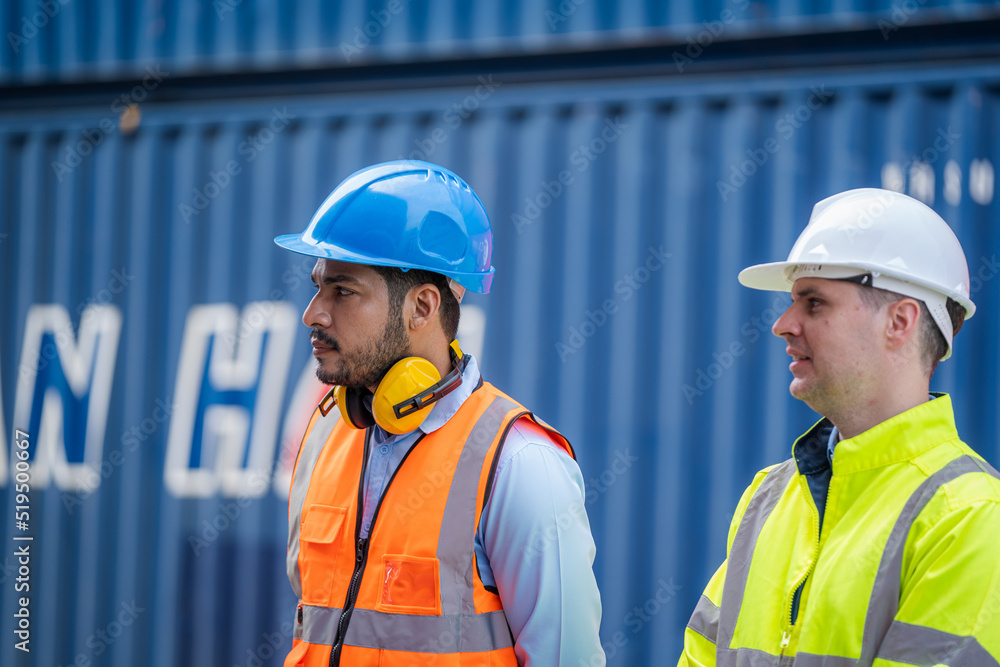 Engineer and inspector working and discuss in shipping container in Container Terminal. Engineer and inspector working and discuss in shipping container in Container Terminal.
