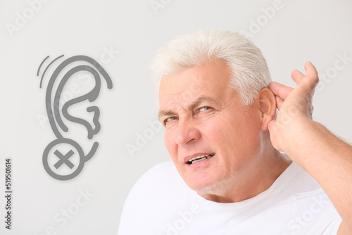 Mature man with hearing pro...
