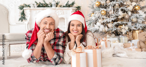 Happy couple in Santa hats ...