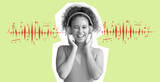 Happy young African-American woman listening to music on green background