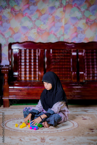 Islamic girl playing with toys
