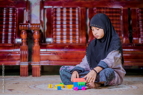 Islamic girl playing with toys