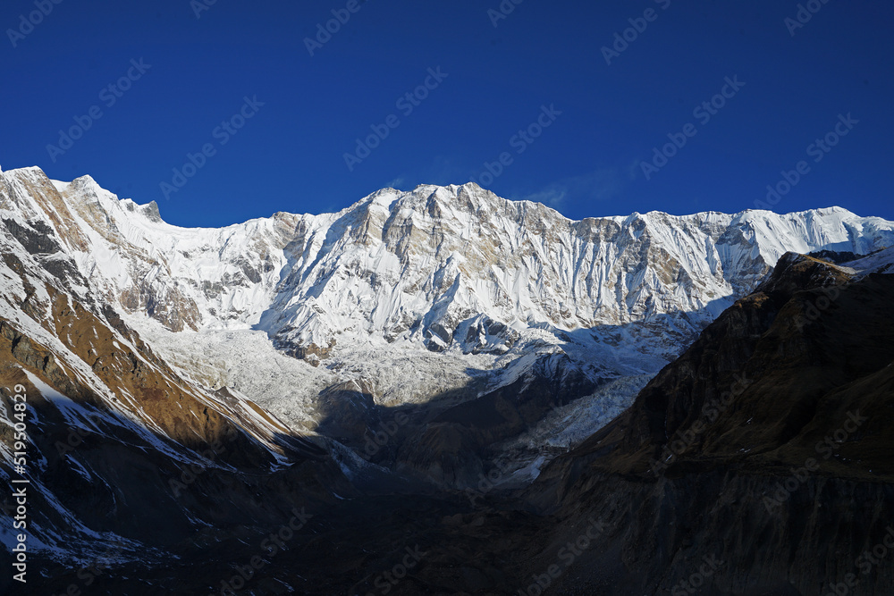Natural landscape of snowy and rocky mountain range with cloudy sky