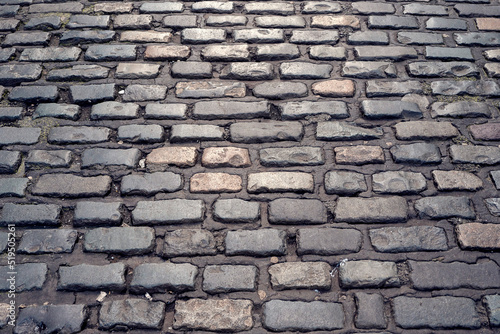 Road or foot path stone surface. Abstract texture for design. Rough stone surface. Traditional construction material