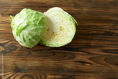 Cabbage cut in half on a wooden background, close-up. Concept - harvesting, home canning. 