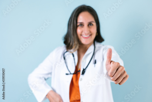 latin doctor woman portrait over blue background laughing in Mexico Latin America 