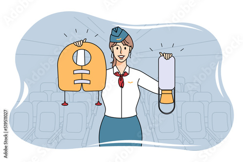 Smiling stewardess showing safety on plane