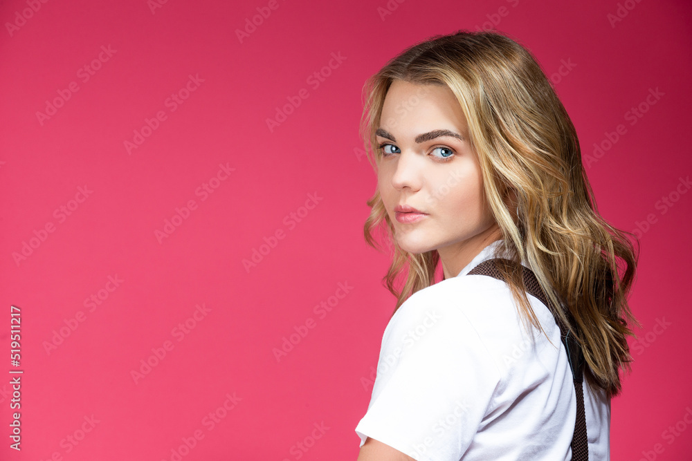 Natural Portrait of Young Sensual Caucasian Female Posing in White Shirt Over Coral Pink with Head Lifted Background. Natural Portrait of Young Sensual Caucasian Female Posing in White Shirt Over Coral Pink with Head Lifted Background.