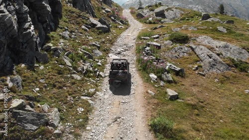 An hard pass through a gravel road with a jeep shot with the drone
