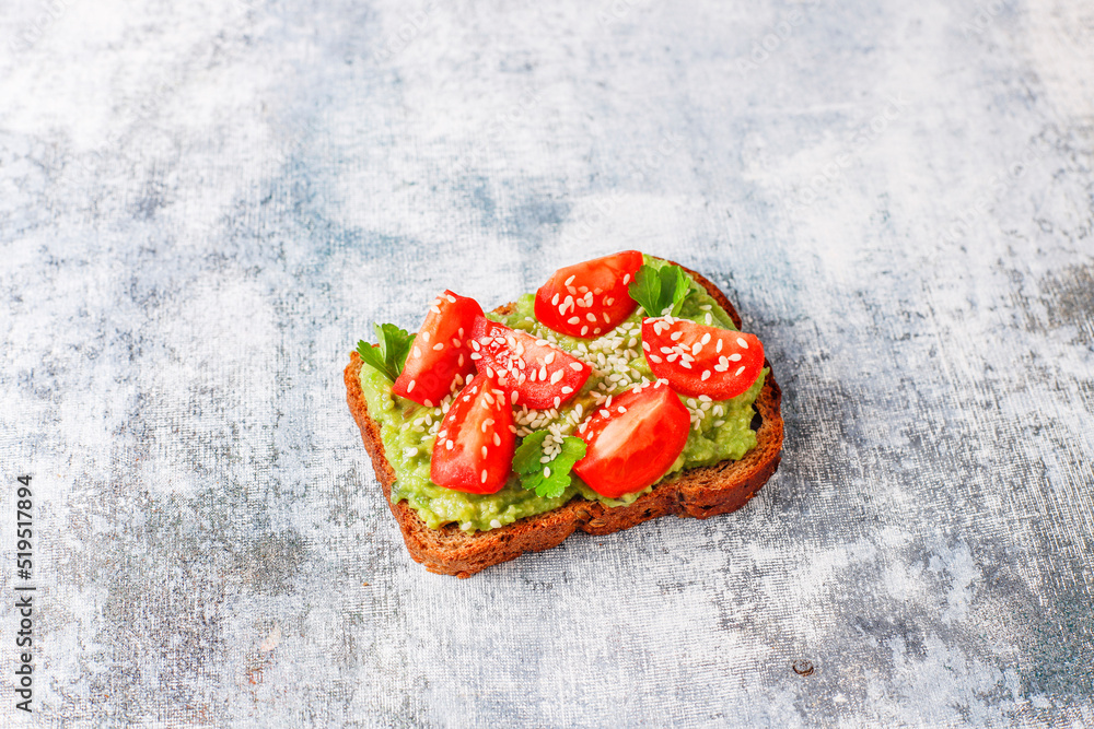 Avocado toasts with cherry tomatoes and raddish slices,sesame seeds. Avocado toasts with cherry tomatoes and raddish slices,sesame seeds.