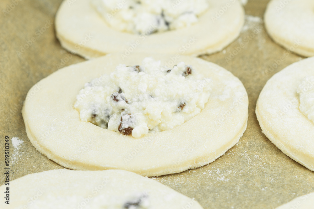 Dough rolled out on the table in the form of cakes Dough rolled out on the table in the form of cakes