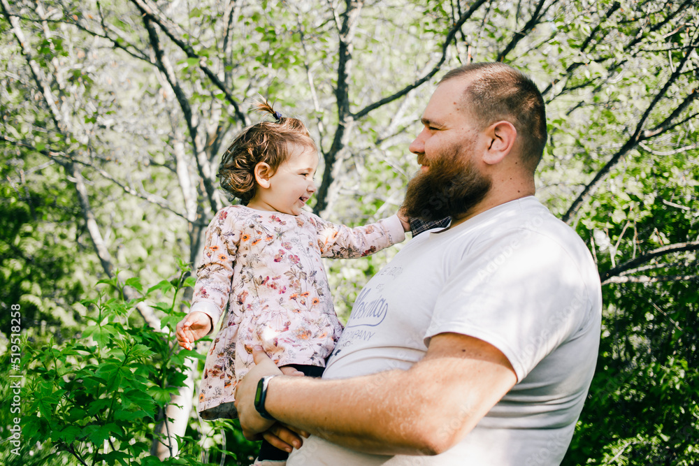 Little girl in fathers hands in the park Little girl in fathers hands in the park