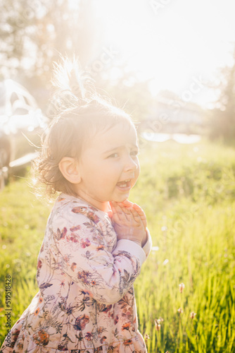 little girl in the field in sunshile light
