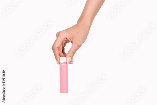 The woman's hand is holding cosmetics.
