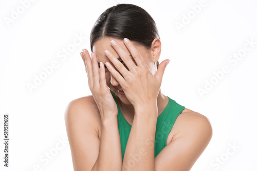 Young caucasian woman laughing and embarrassed covering face with hands