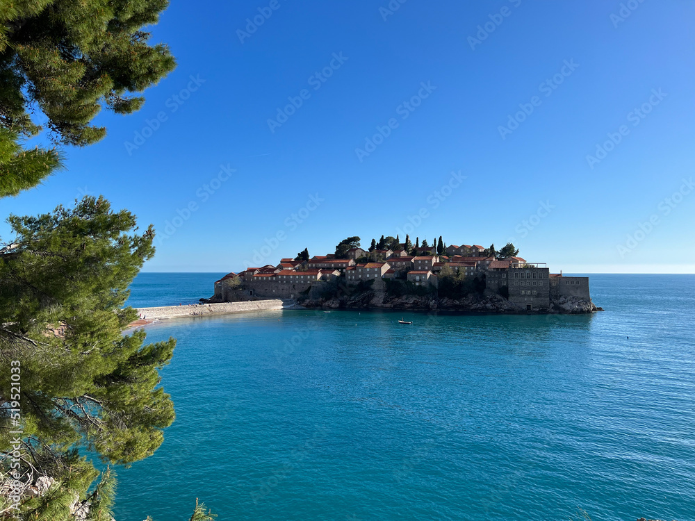 Sveti Stefan island against the blue sky and the sea. Montenegro