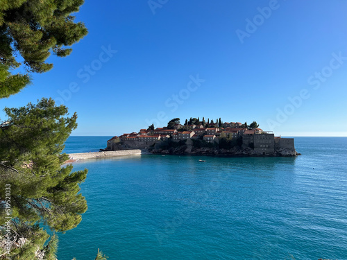 Sveti Stefan island against the blue sky and the sea. Montenegro