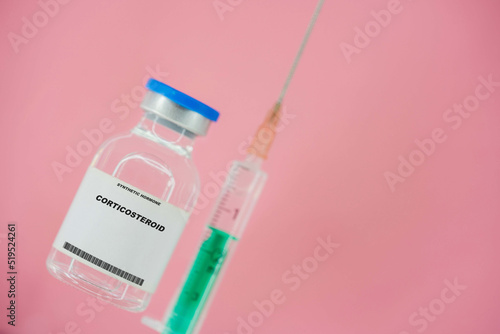 Corticosteroid. Test tube with artificial hormone on pink background Corticosteroid photo