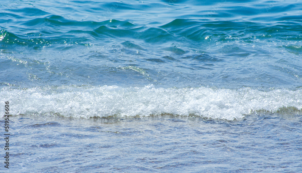 Soft wave of sea on sandy beach. Background.