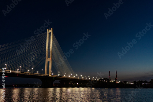 Fototapeta Naklejka Na Ścianę i Meble -  The South bridge at night, Kyiv, Ukraine. Bridge at sunset across the Dnieper River.