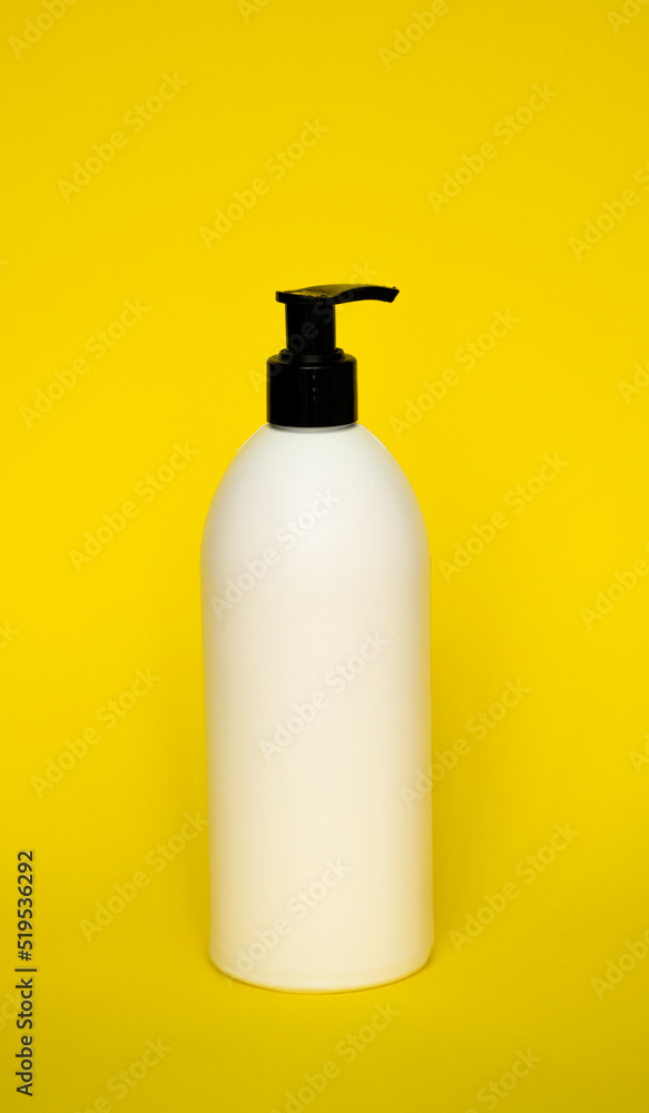 White plastic soap dispenser pump bottle isolated on yellow background. Skin care lotion. Bathing essential product. Shampoo bottle. Bath and body lotion. Fine liquid hand wash. Bathroom accessories. White plastic soap dispenser pump bottle isolated on yellow background. Skin care lotion. Bathing essential product. Shampoo bottle. Bath and body lotion. Fine liquid hand wash. Bathroom accessories.