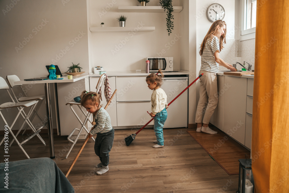 Kids helping their mother to clean the kitchen