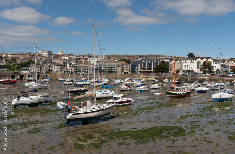 Penzance, Cornwall, England, UK. 2022. Penzance Harbour with boats settled on the mud with a backdrop of the town centre. Cornwall UK.
