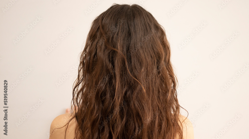 Naklejka premium Curly brunette girl with natural curly hair. Wavy curls, cgm
