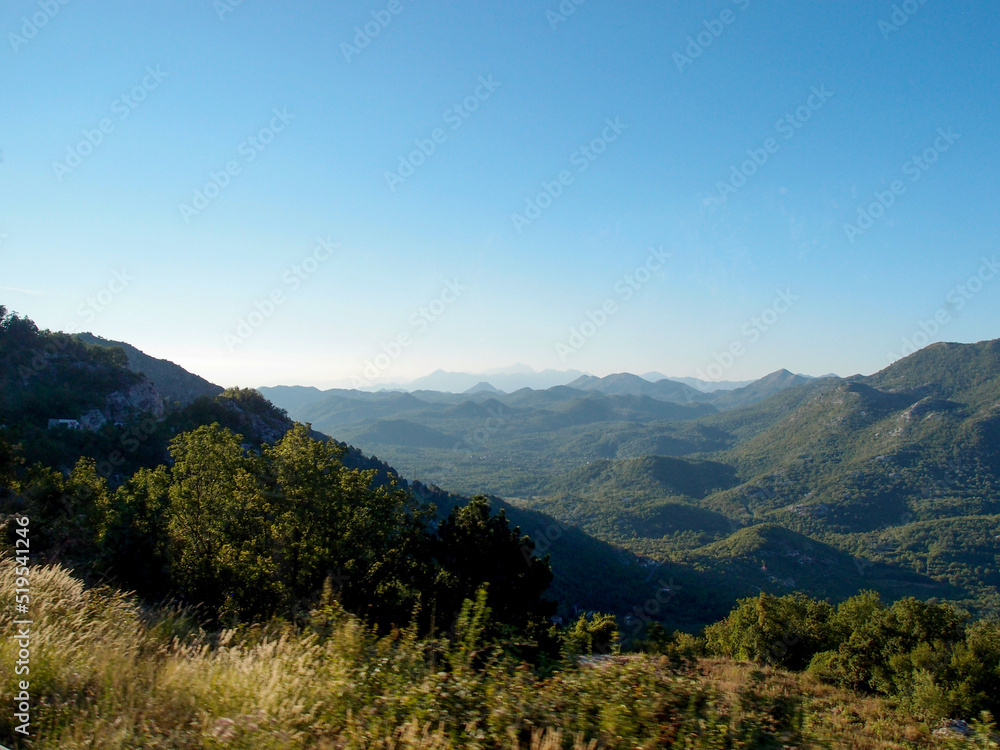 Scenic mountain landscape, view of the mountain range with the forest, green trees, and blue sky