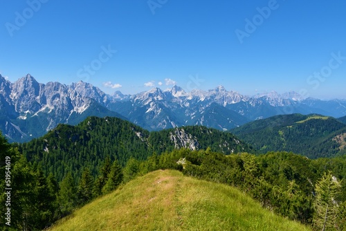 View of mountain peaks in Julian alps and Triglav national park, Slovenia and a ridge in Karavanke mountains bellow Trupijevo Poldne