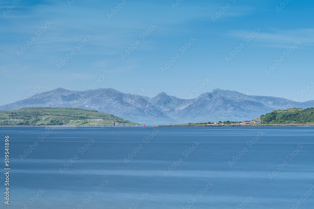 A hazy Isle of Arran taken on a bright sunny day in Scotland's Portencross Bay