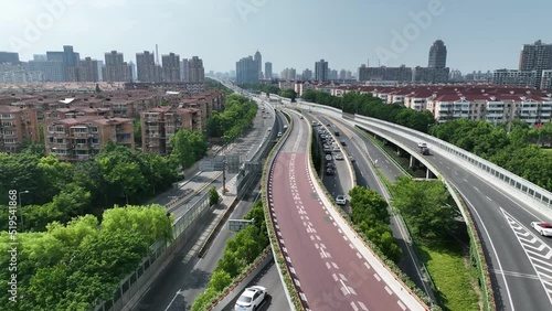 Timelapse of Traffic lane and highway in the city. Drone aerial view. Busy traffic interchange in the downtown in rush hour. Complicated road. Business, industry and travel concept b-roll footage.