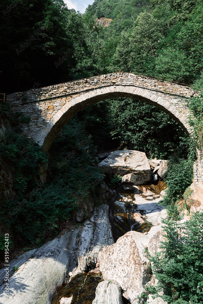 Aosta Valley, Italy - The ancient Roman bridge over the river in the little village named ( Pontboset).