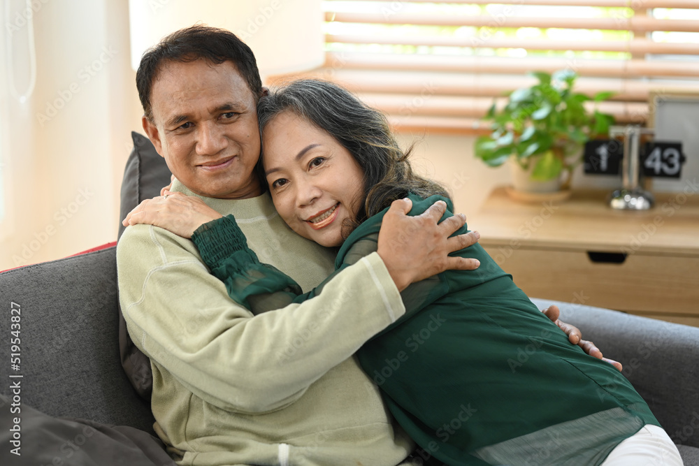 Romantic senior couple relaxing on couch, spending time together at home Romantic senior couple relaxing on couch, spending time together at home