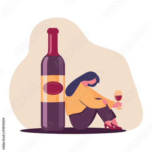 The concept of female alcoholism. The unfortunate woman is sitting on the floor near a bottle of wine holding a glass of wine. Sad drunk wife or alcoholic mother. Social problem, abuse, addiction.