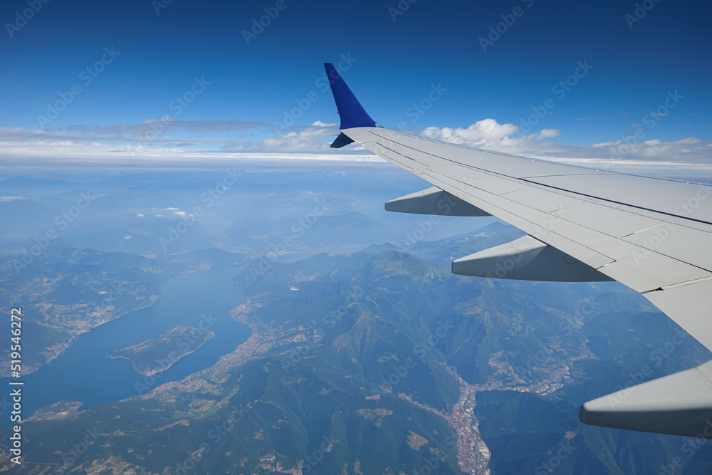 Fototapeta premium Travel to Italy. Beautiful view from an airplane flying over spectacular Lake Como landmark next to Milan.