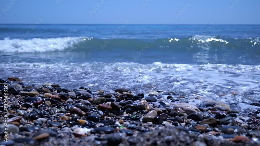 Slow Motion Of Waves Crashing On Pebbled Shoreline In Mediterranean Sea. Closeup Slow Motion Of Waves Crashing On Pebbled Shoreline In Mediterranean Sea. Closeup