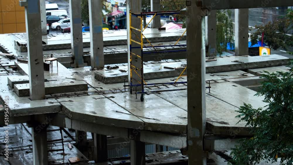 Construction site in the rain on the background of walking people, cars ...