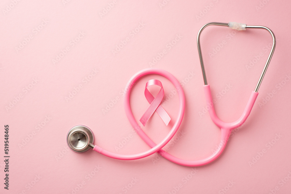 Breast cancer awareness concept. Top view photo of pink silk ribbon and stethoscope on isolated pastel pink background Breast cancer awareness concept. Top view photo of pink silk ribbon and stethoscope on isolated pastel pink background