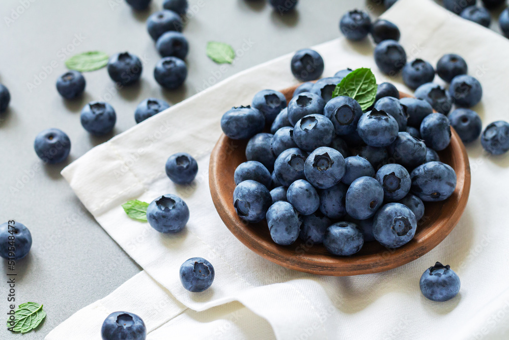 Bowl or plate blueberries blueberry with leaves on kitchen table Bowl or plate blueberries blueberry with leaves on kitchen table