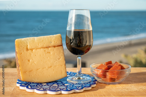Tasting of sweet Spanish fortified Pedro Ximenez sherry wine with manchego cheese made with same sherry wine in El Puerto de Santa Maria, Andalusia, Spain
