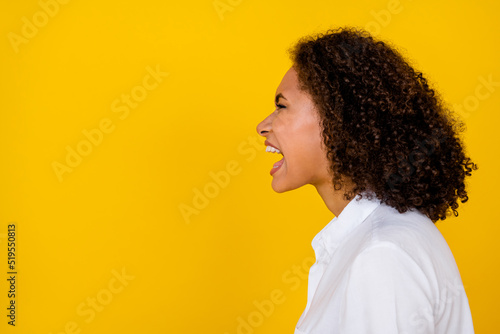 Profile photo of emotional woman open mouth scream say sale look empty space for advertisement isolated on yellow color background.