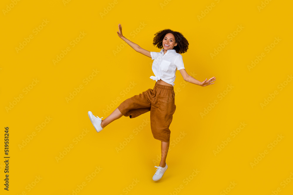 Full body portrait of excited crazy person jumping enjoy free time isolated on yellow color background Full body portrait of excited crazy person jumping enjoy free time isolated on yellow color background