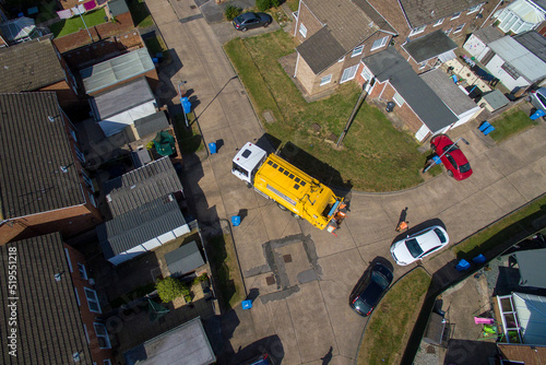 aerial view of refuse collecting lorry collecting domestic rubbish from homes using the wheelie bin system, City waste manage and recycling 