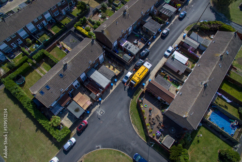 aerial view of refuse collecting lorry collecting domestic rubbish from homes using the wheelie bin system, City waste manage and recycling 