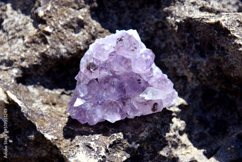 A beautiful amethyst druze lies on a stone. A splice of purple crystals of semi-precious quartz.