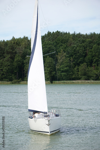 Fototapeta Naklejka Na Ścianę i Meble -  Sailboat swimming on a lake - front view