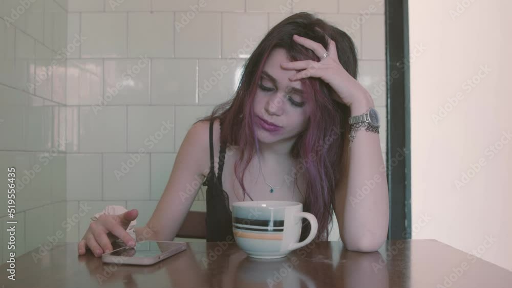 End of a relationship. Young woman was left with a message on the smartphone End of a relationship. Young woman was left with a message on the smartphone