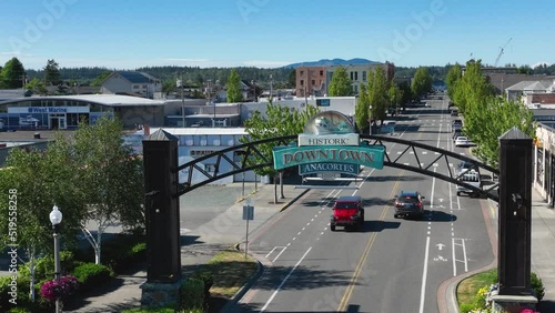 Aerial shot of cars passing underneath the Anacortes, WA welcome sign on main street. photo