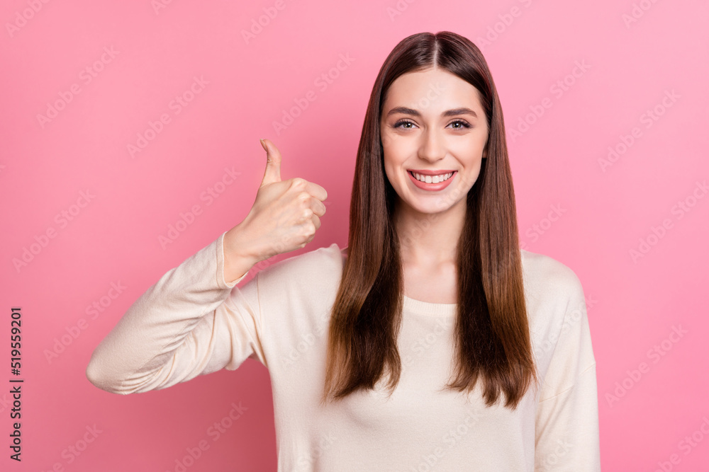 Portrait of attractive cheerful brown haired successful girl showing thumbup ad isolated over pink pastel color background Portrait of attractive cheerful brown haired successful girl showing thumbup ad isolated over pink pastel color background
